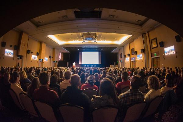John Holdren speaks to a packed High Camp audience during Mountaintilm's 2017 Moving Mountains Symposium. (Photo by Melissa Plantz/Mountainfilm)