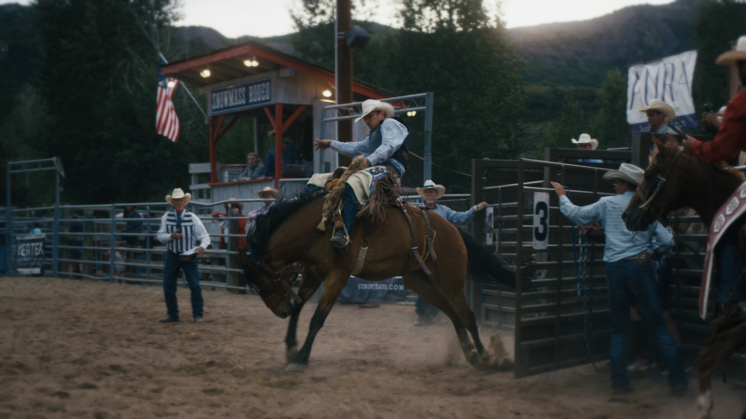 Film still from Buckwild: a bronco rider on a bucking horse at a rodeo